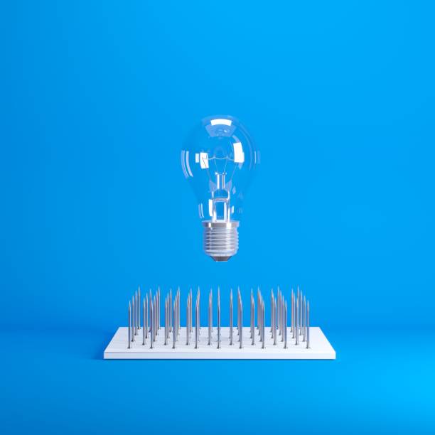 istock Levitating Lightbulb floating on top nail trap on blue background color. minimal idea concept. 1002551622