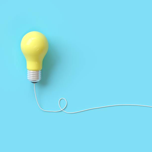 istock Yellow light bulb with wire on blue background for copy space. minimal idea concept. top view 1002552028