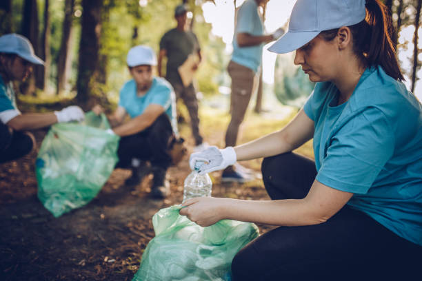 Cleaning the environment together Group of people, cleaning together in public park, saving the environment. plastic pollution photos stock pictures, royalty-free photos & images