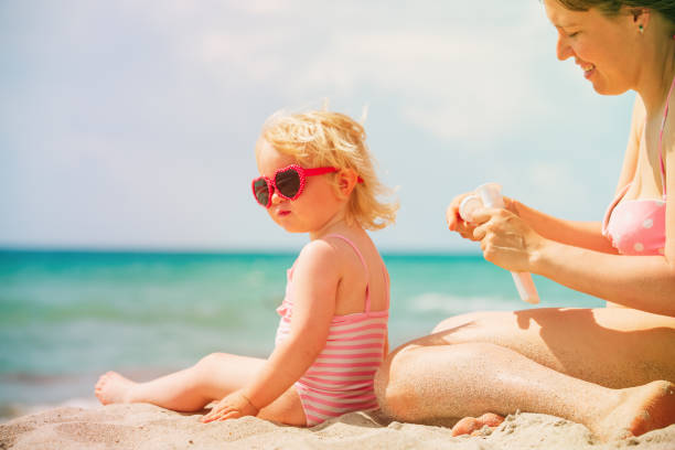 istock mother applying sunblock cream on daughter shoulder 1002563832