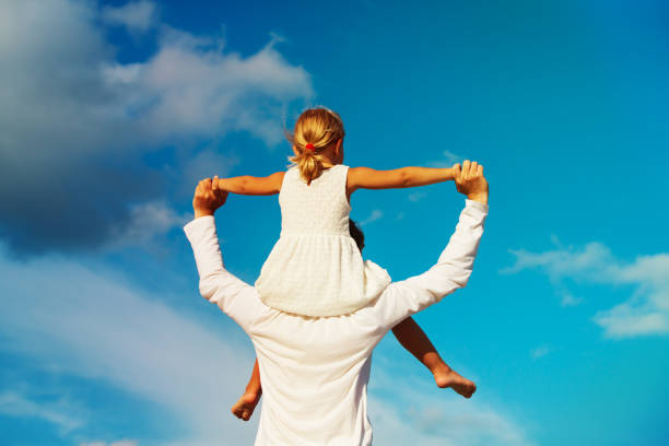 istock father and little daughter play at sky 1002563994