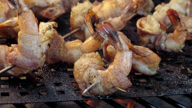istock Bacon Wrapped Jumbo Shrimp or Prawns on a Grill 1002592608