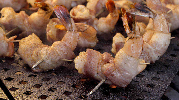 istock Bacon Wrapped Jumbo Shrimp or Prawns on a Grill 1002592680