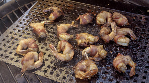 istock Bacon Wrapped Jumbo Shrimp or Prawns on a Grill 1002592710