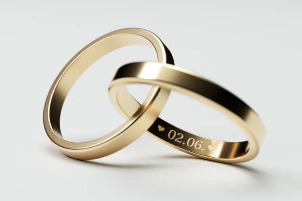 istock Isolated golden wedding rings with date 2. June 1002598258