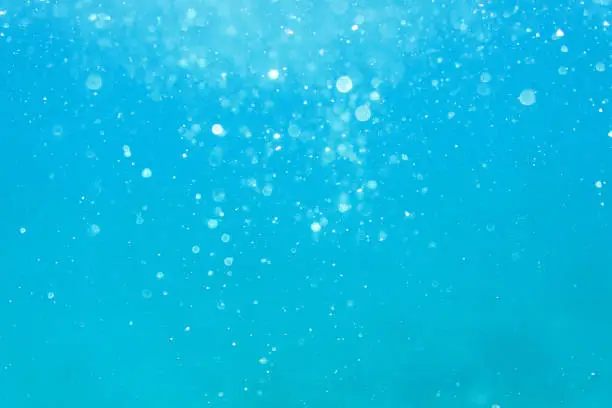 Photo of Underwater turquoise texture in ocean. Bubbles in tropical sea.