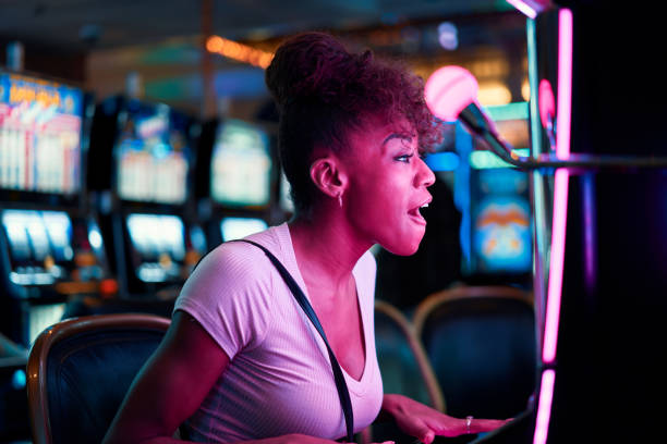 istock woman having fun playing slot machine at casino 1002601706