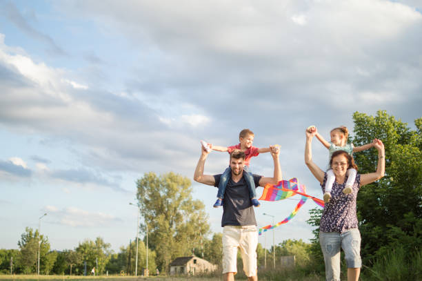 istock Family having fun flying kite 1002612198