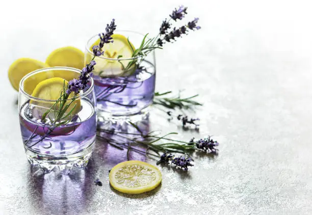 Drink with lemon and lavender flowers. Cold summer lemonade
