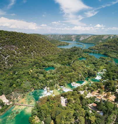 Aerial of the famous staircase waterfalls at the beautiful Krka National Park, Croatia. You can see thousands of tourists bathing by the bridge and the lower bay. Converted from RAW.