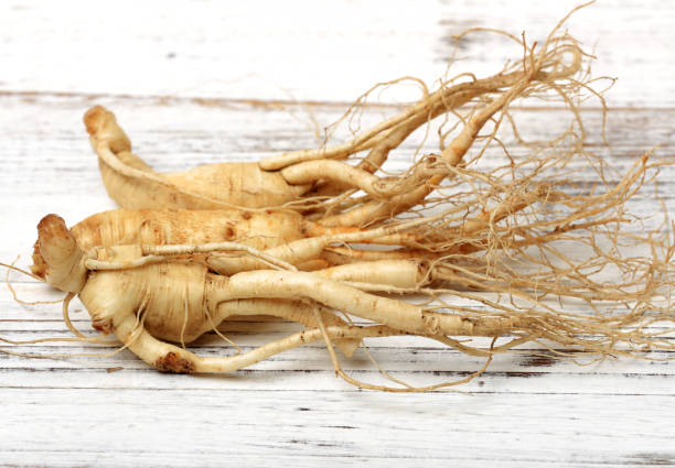 istock Ginseng  isolated on white wood  background 1002625948