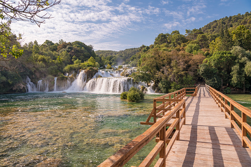 Unique shot of wooden bridge by the famous staircase waterfalls at the beautiful Krka National Park, Croatia. Take right before thousands of tourists fill up this place. Converted from RAW.