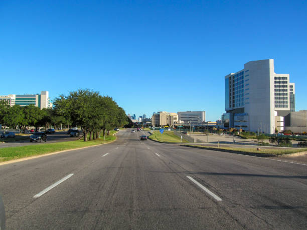Beautiful view of city asphalt street on sunny day against a blue sky. Skyline of urban architecture.