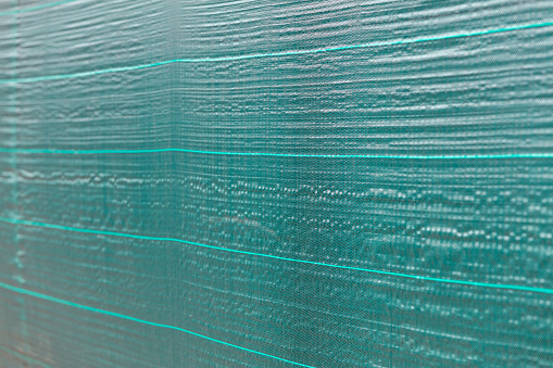 green protective net cloth background. building construction site with plastic cover