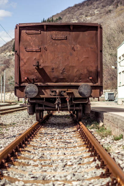 vista industriale sul retro di un vagone marrone ricoperto di ruggine. - automovil foto e immagini stock