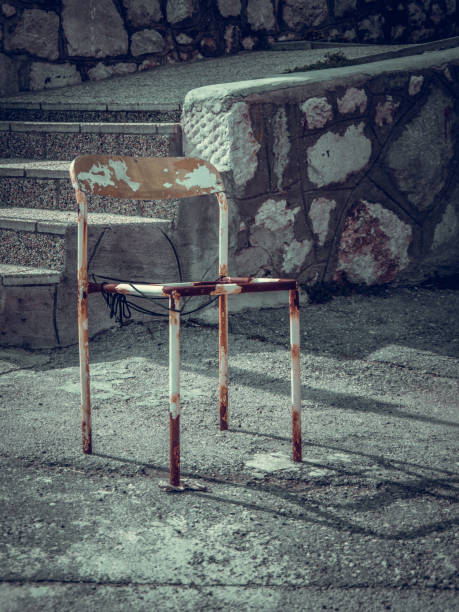 istock Old rusted chair standing on the street. 1002631386