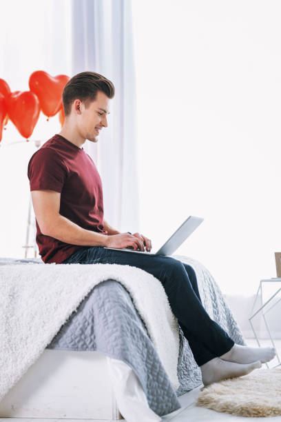 istock Profile photo of delighted man that looking at computer 1002650674