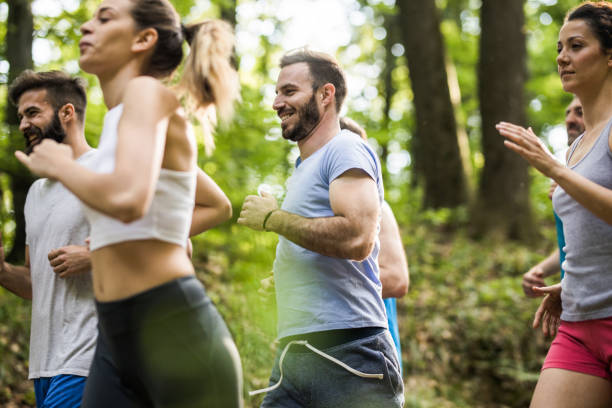 istock Happy marathon runners running a race through nature. 1002656142