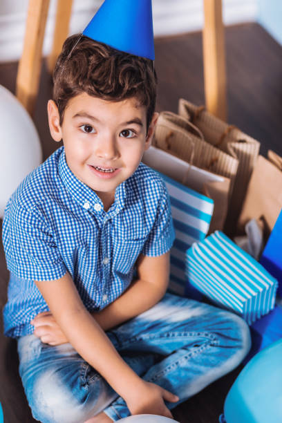 istock Handsome child sitting near his presents 1002666704