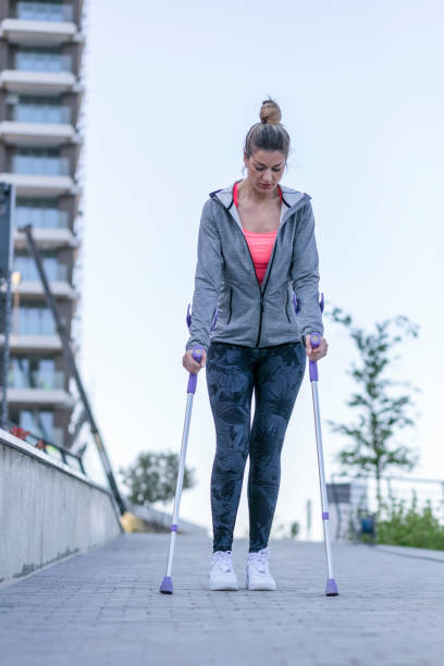 istock Young beautiful woman with crutches 1002667174