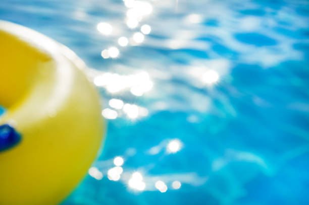 istock Yellow swim ring in a swimming pool with rippled water, backgrou 1002667424