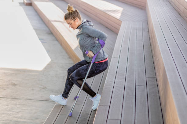 istock Young beautiful woman with crutches 1002667774
