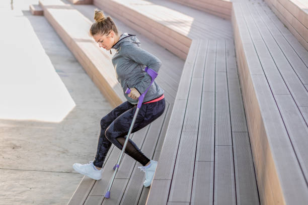 istock Young beautiful woman with crutches 1002667974