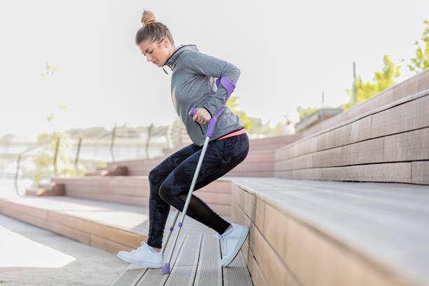 istock Young beautiful woman with crutches 1002668208