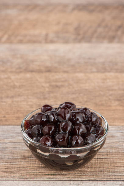 istock Tapioca Pearl , Bubble topping for tea or other beverage, in a cup, place on wooden table. Copy space 1002670854