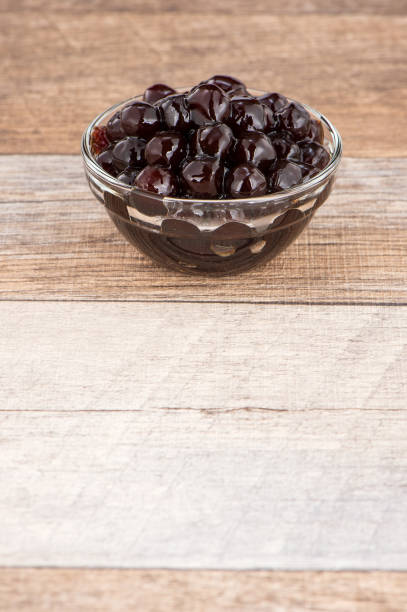 istock Tapioca Pearl , Bubble topping for tea or other beverage, in a cup, place on wooden table. Copy space 1002670858