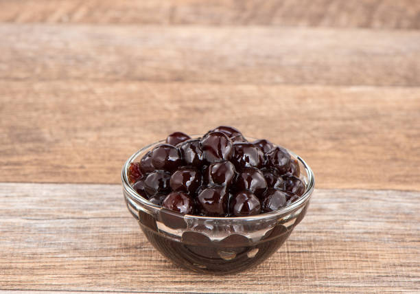 istock Tapioca Pearl , Bubble topping for tea or other beverage, in a cup, place on wooden table. Copy space 1002670938