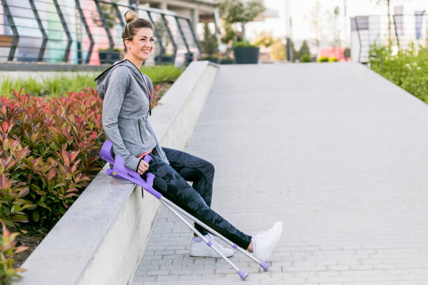 istock Young beautiful woman with crutches 1002670982
