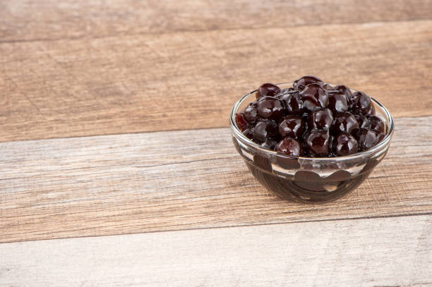 istock Tapioca Pearl , Bubble topping for tea or other beverage, in a cup, place on wooden table. Copy space 1002671060