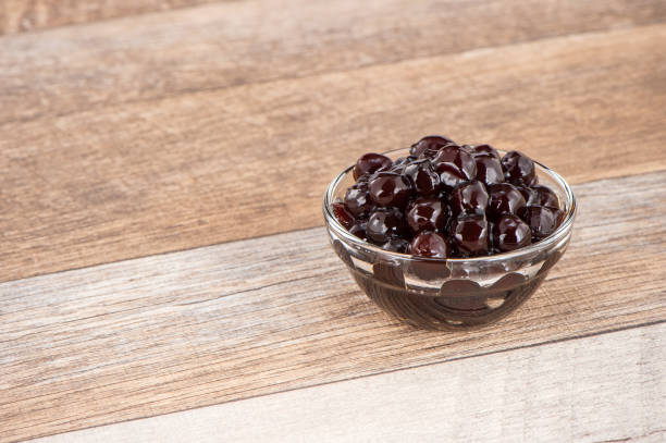 istock Tapioca Pearl , Bubble topping for tea or other beverage, in a cup, place on wooden table. Copy space 1002671100