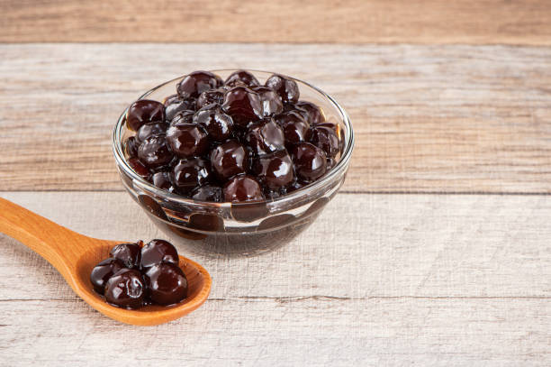 istock Tapioca Pearl , Bubble topping for tea or other beverage, in a cup, place on wooden table. Copy space 1002671186