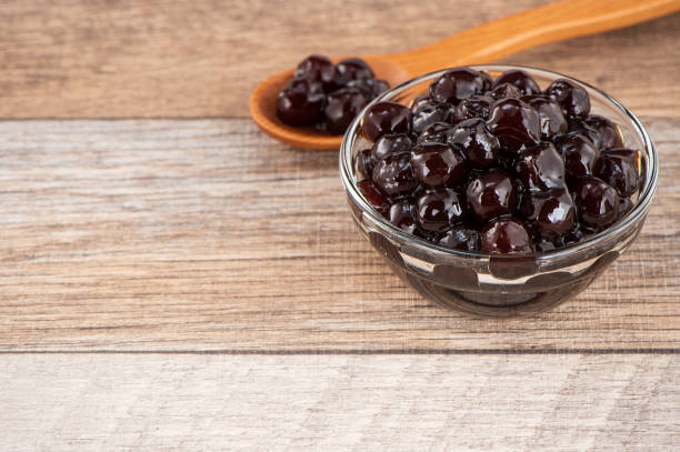 istock Tapioca Pearl , Bubble topping for tea or other beverage, in a cup, place on wooden table. Copy space 1002671244