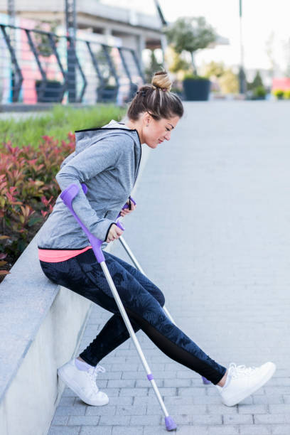 istock Young beautiful woman with crutches 1002671356