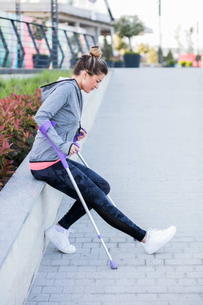 istock Young beautiful woman with crutches 1002671396