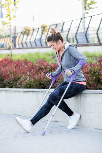 istock Young beautiful woman with crutches 1002671498