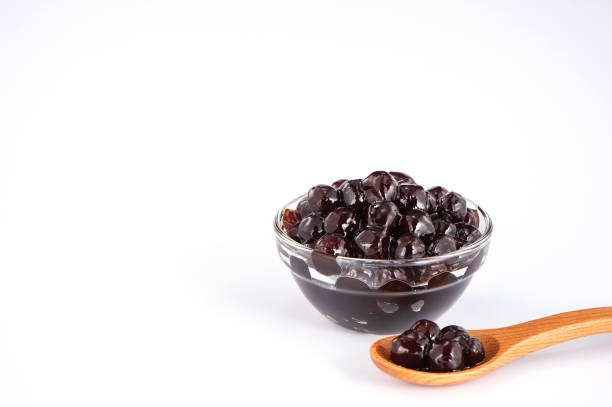 istock black pearls. Boiled tapioca pearls for bubble tea on white background. Copy space 1002671528