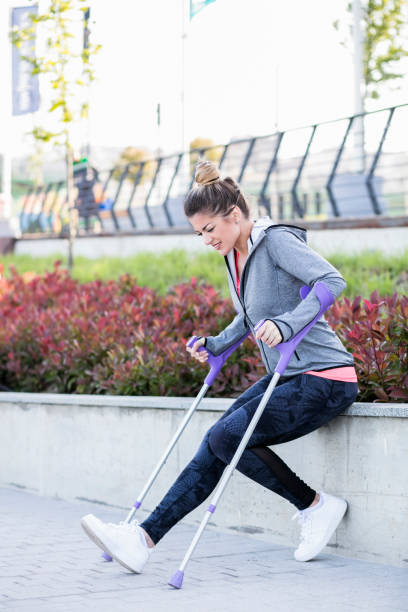 istock Young beautiful woman with crutches 1002671532