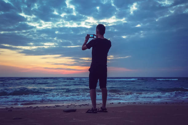 istock Silhouette of man keep memories with camera 1002671566