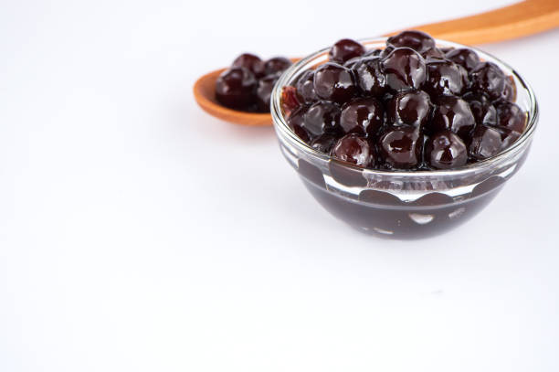 istock black pearls. Boiled tapioca pearls for bubble tea on white background. Copy space 1002671574