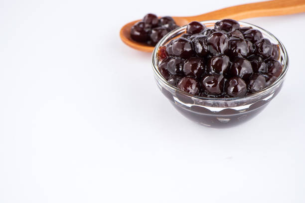 istock black pearls. Boiled tapioca pearls for bubble tea on white background. Copy space 1002671594