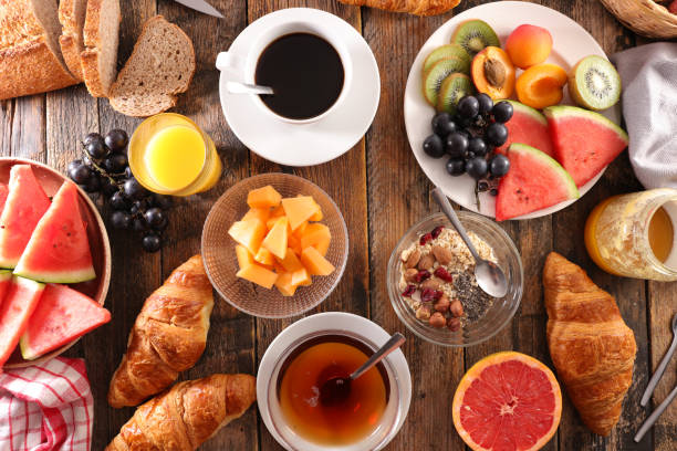 istock coffee with fruit, cereal and croissant 1002671652