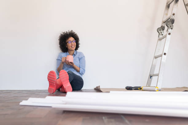 istock Young woman taking a break from DIY 1002671694