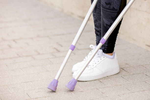 istock Young beautiful woman with crutches 1002671752