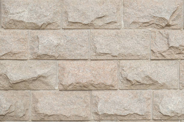 áspera textura piedra mármol beige - retaining wall fortified wall surrounding wall stone wall fotografías e imágenes de stock