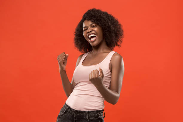 istock Winning success woman happy ecstatic celebrating being a winner. Dynamic energetic image of female afro model 1002675232