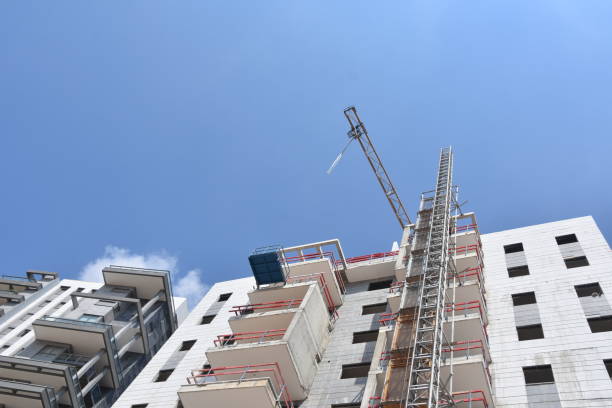istock Looking up on the construction of a residential tower 1002677884